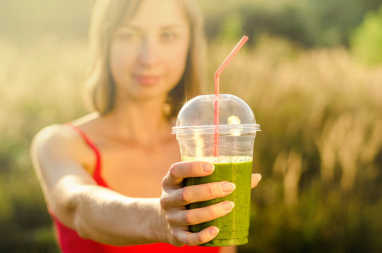 Diet. Drink organic smoothie. Smiling healthy woman drinking fresh green detox vitamin vegetable juice. Healthy fit sport lifestyle vegetarian food. Nutrition Concept apple kale shpinach mint