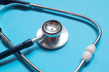 Stethoscope on blue background. Healthcare and medical concept.