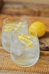 Fresh lemonade with ice and lemon on the table 