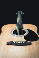 Fototapeta premium part of the guitar, neck, a grey and black background, beautifully, elegantly