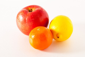 apple, lemon, orange on a gray background