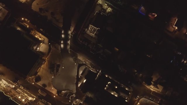 Aerial rotating shot cars in cool little mountain town at night in winter
