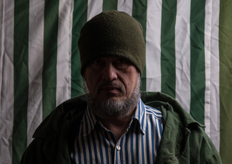 portrait of a man on a striped background