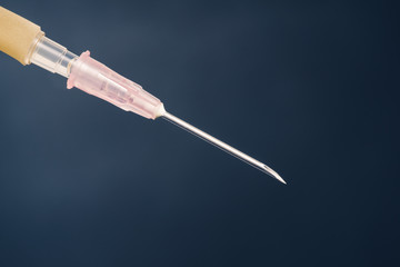 disposable hypodermic needle use for infusion set or syringe against dark background