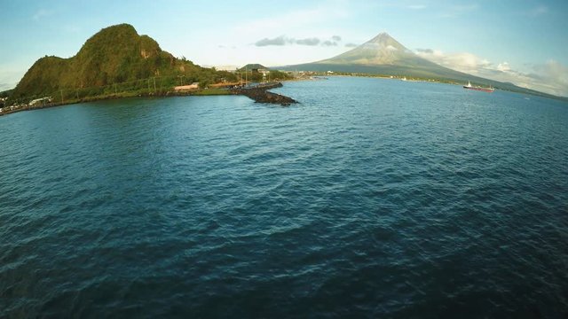 Aerial panorama of the city of Legaspi in the morning at dawn. Against the backdrop of the Mayon volcano. Seaport with boats.
