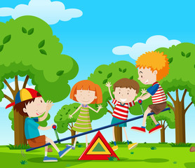Obraz na płótnie Canvas Children playing seesaw in the park