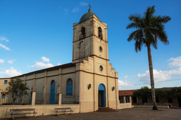 Fototapeta na wymiar Church of vinales and palm at sunset