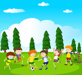 Obraz na płótnie Canvas Boys playing soccer in park