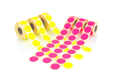 Colored label rolls isolated on white background with shadow reflection. Color reels of labels for...