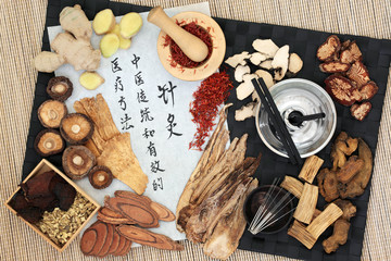 Chinese acupuncture needles and moxa sticks used in moxibustion therapy with herbs and calligraphy...