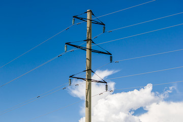 Obraz premium Pole lines on a background of clouds and blue sky