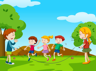 Children jumping rope in the park