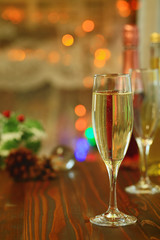 Two glasses of Sparkling wine in front of defocused colorful lights, evening warm tone background.