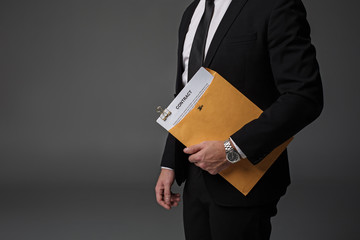 Close up businessman arm keeping contract in folder. Career concept. Isolated and copy space