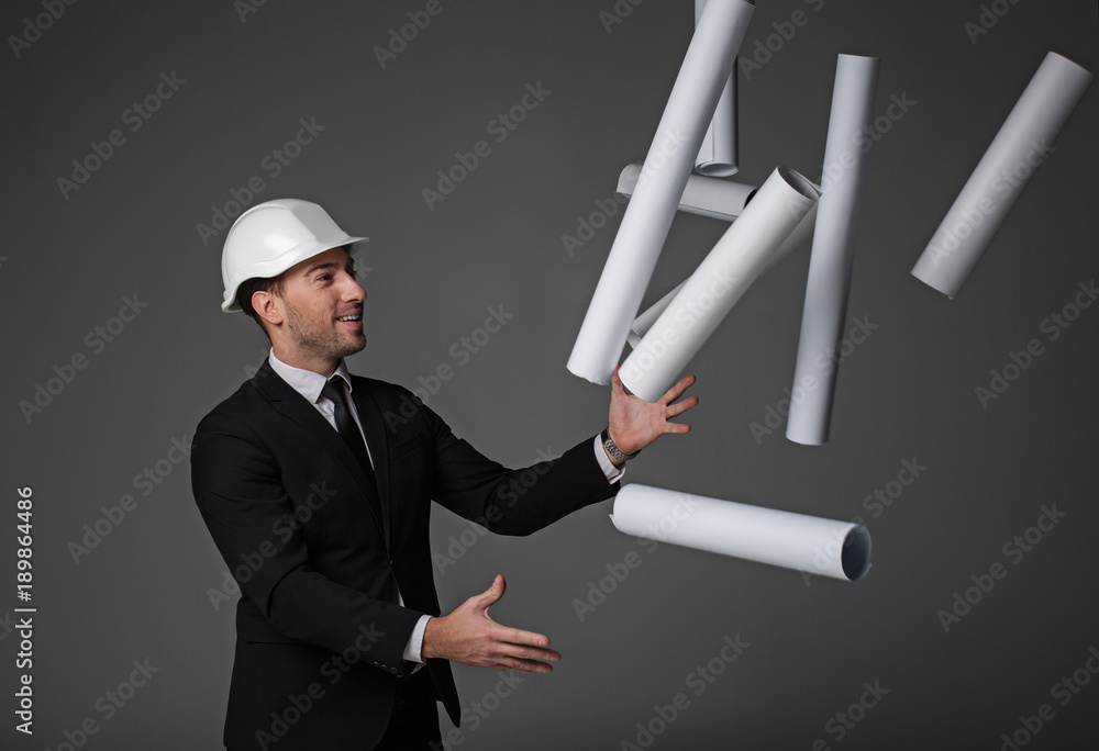 Aufkleber side view smiling unshaven builder juggling different projects. he gesticulating arms. profession co