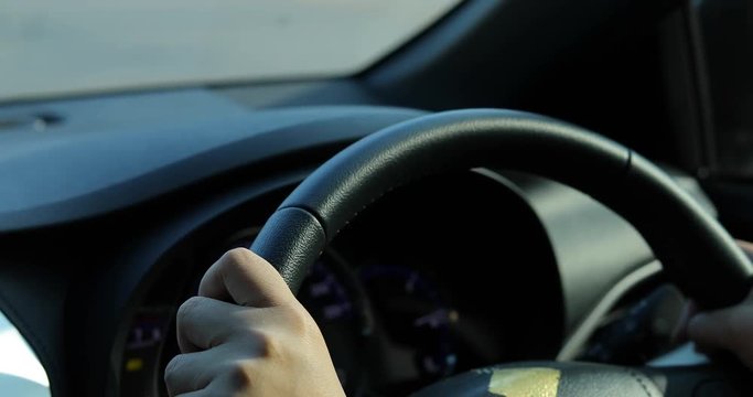 woman hand driver control steering wheel driving car of curved road