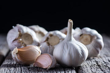 Organic garlic whole and cloves on the wooden background