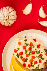 Vegetarian Snack of Hummus with Red Peppers Parsley Lemon and Rye Bread