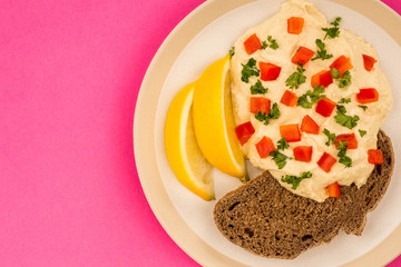 Vegetarian Snack of Hummus with Red Peppers Parsley Lemon and Rye Bread