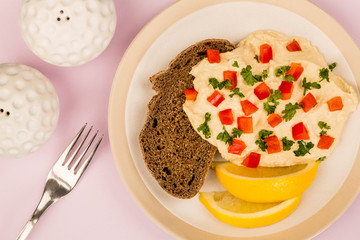 Vegetarian Snack of Hummus with Red Peppers Parsley Lemon and Rye Bread