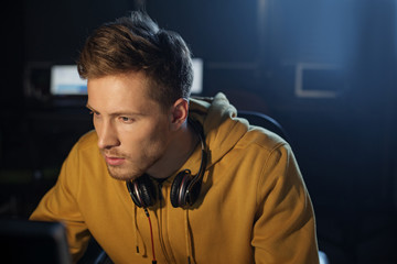 Portrait of calm bearded software specialist working with computer. Labor concept