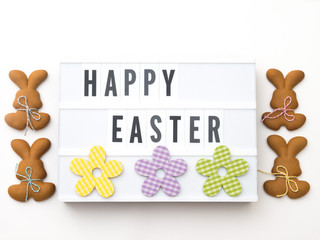 HAPPY EASTER word on lightbox. Easter background. Easter baking. Making gingerbread easter cookies. Easter concept.