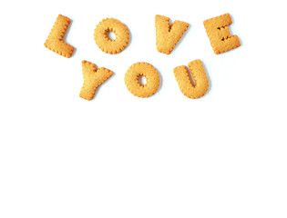 The word LOVE YOU spelled with alphabet shaped biscuits, isolated on white background with free space for text and design 