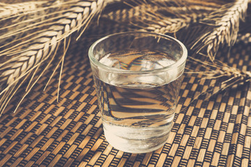 A glass of strong German schnapps on a bamboo background. Vintage.