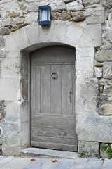 Vintage wooden door in a stone wall. Close up.