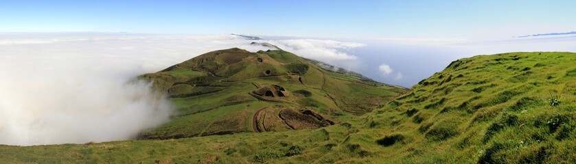 Green crater landscape above the clouds at Sao Jorge Island at the Azores, Portugal
