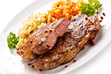 Grilled steak with vegetables on white background 