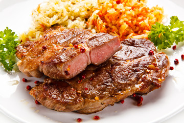 Grilled steak with vegetables on white background 