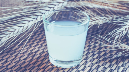 The glass of vodka on a bamboo background. Vintage.
