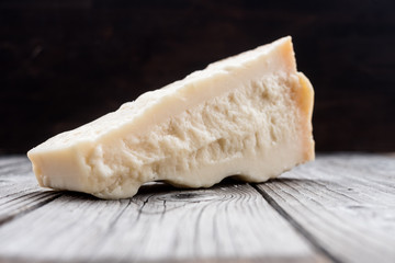 Italian hard cheese  on the old wooden table
