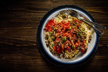Spaghetti with meat, tomato sauce and herbs