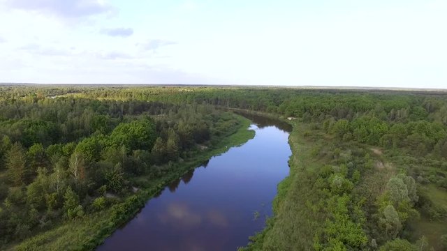 Aerial view. River in the Chernobyl zone. The radioactive river is already flowing among the forest