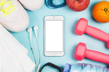 Sports shoes, dumbbell fitness in the blue background. Different sports tools