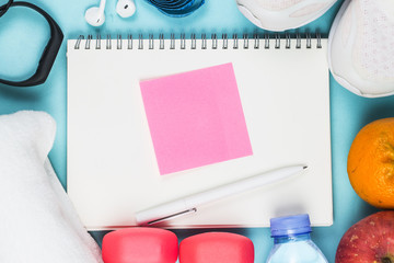 Sports shoes, dumbbell fitness in the blue background. Different sports tools