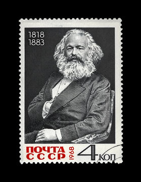 Karl Marx (1818-1883), famous politician leader, Capital book author, circa 1968. Vintage postal stamp printed in the USSR isolated on black background.
