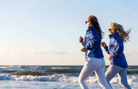 Middle-aged Women Running On Beach