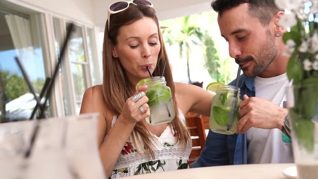 Couple of tourists drinking mojitos