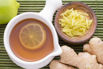 roots of ginger and lemon on wooden table