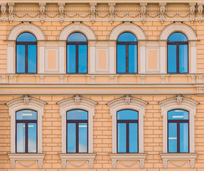 Several windows in a row on the facade of the urban historic building front view, Saint Petersburg, Russia
