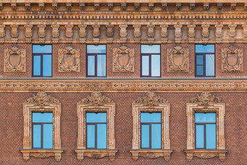 Several windows in a row on the facade of the urban historic building front view, Saint Petersburg, Russia
