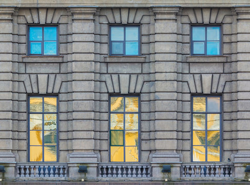 Several windows in a row on the facade of the urban historic building front view, Saint Petersburg, Russia
