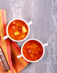 Sausage and red lentil soup, in bowls