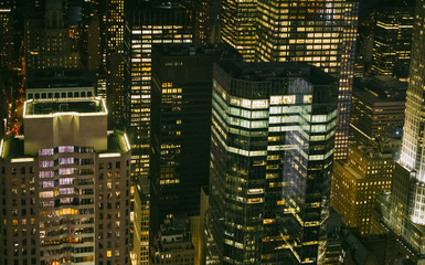 Background of skyscrapers windows illuminated at night in Manhattan, New York City