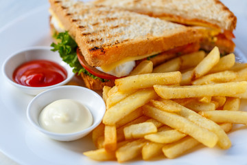 Delicious club sandwich with french fries at a diner.