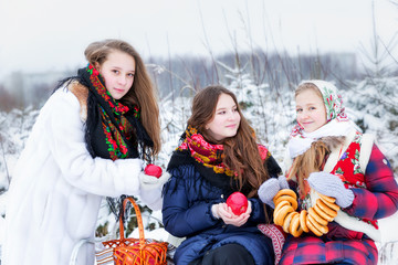 Girls in Russian national clothes in the winter landscape