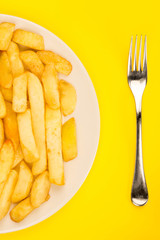 Plate of Fried Chips With A Fork and Copy Space